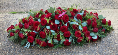 Red Rose Coffin Spray - An elegant spray of all  Red Roses and complimentary foliage.  Other colours are available. White, Pale Pink, Cerise Pink Yellow, Orange, Lilac, Mixed.  Please specify colour in special requirements or contact the shop.