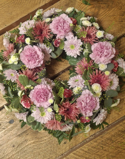 Pink Wreath - Traditional wreath in pink colours.  Florist choice of flowers.  If you have any flowers you would like, then please put it in the special requests box.