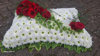 Traditional Based Pillow - Based with white Chrysanthemums and a foliage edging, with a spray of flowers on top.  Please add your colour requests to the special requests box when ordering.