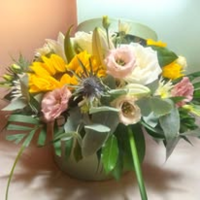 Florist Choice Hat Box Arrangement - A beautiful arrangement of seasonal flowers and colours, designed in a solid hat box with a sturdy plastic waterproof liner.  If you have a specific colour you would like, please state in the special instructions box when ordering.