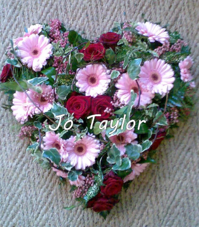 Pink & Red Heart - Pretty pink and red heart featuring red Roses and pink Germini, grouped together with Ivy and a pink filler flower.