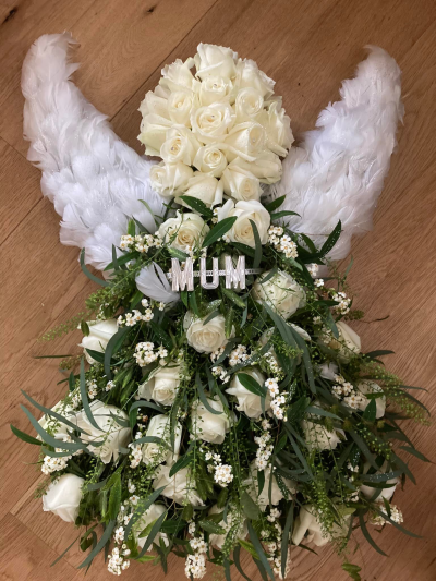 Angel - Angel tribute Approx 24".  Feathered wings, Rose head,  Roses, filler flower and foliage for her body/ Flowers available in white, pink, lilac, yellow, orange, red.  Please specify colour choice in the special instruction box or phone to discuss.
